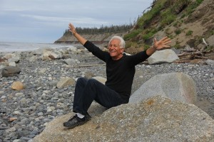 A happy old man sat on a rock