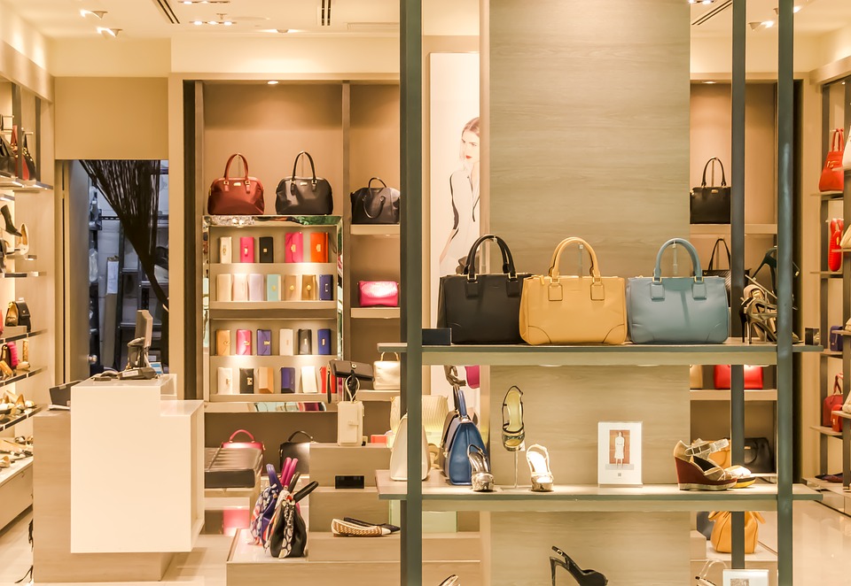 A shop window with handbags, shows and purses on display.