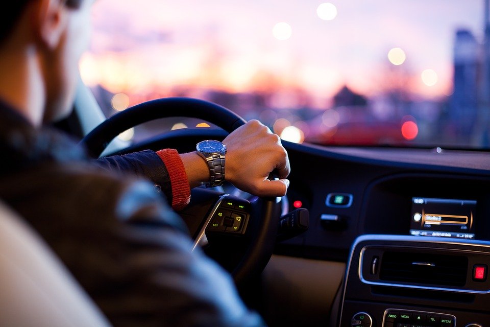 Man drives car with lower body driving aids